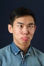 Funny young Asian man making face Royalty Free Stock Photo