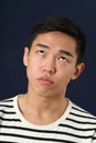 Funny young Asian man making face and rolling eyes up Royalty Free Stock Photo