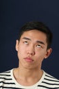 Funny young Asian man making face and rolling eyes up Royalty Free Stock Photo