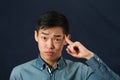 Funny young Asian man pointing his index finger Royalty Free Stock Photo