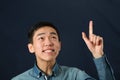 Funny young Asian man pointing his index finger up Royalty Free Stock Photo