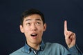 Funny young Asian man pointing his index finger upward Royalty Free Stock Photo