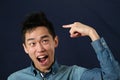 Funny young Asian man pointing the index finger at haircut Royalty Free Stock Photo