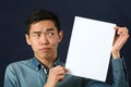 Funny young Asian man showing white copy space page Royalty Free Stock Photo