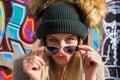 Funny young blonde woman in hat and sunglasses looking at camera Royalty Free Stock Photo