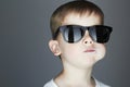 Funny Young Boy Eating A Lollipop.child in sunglasses Royalty Free Stock Photo