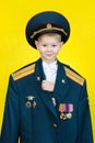 City of Yasny, Orenburg region, Russia, Photosession in studio, 02/18/2018. A little boy in the military uniform of his father.