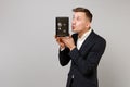 Funny young business man in suit blowing sending air kiss to metal bank safe for money accumulation in hand isolated on Royalty Free Stock Photo