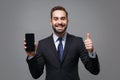 Funny young business man in suit shirt tie posing isolated on grey background. Achievement career wealth business Royalty Free Stock Photo