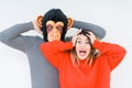 Funny young couple, boyfriend wearing monkey mask, crazy and idiot relationship in love