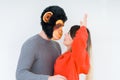 Funny young couple, boyfriend wearing monkey mask, crazy and idiot relationship in love