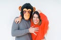 Funny young couple, boyfriend wearing monkey mask, crazy and idiot relationship in love