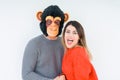 Funny young couple, boyfriend wearing monkey mask, crazy and idiot relationship in love