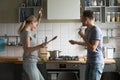 Funny young couple dancing together enjoying cooking in the kitc Royalty Free Stock Photo