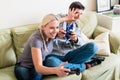 Funny young couple playing together a video game on console Royalty Free Stock Photo