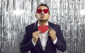 Funny man in suit and heart glasses holding Valentine card and pouting his lips for kiss Royalty Free Stock Photo