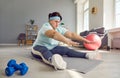 Fat overweight funny woman wearing sportswear doing stretching exercise on the floor at home. Royalty Free Stock Photo
