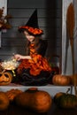 Girl in halloween costume with magic pot Royalty Free Stock Photo