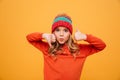 Funny Young girl in hat showing thumb up and down Royalty Free Stock Photo