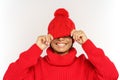 Funny black girl hide eyes under trendy knitted hat happy smiling. Overjoyed african woman has fun Royalty Free Stock Photo