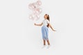 Funny young girl jumping high celebrating and holding colorful balloons isolated on white background. Birthday party Royalty Free Stock Photo