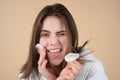 Funny young girl with daily morning skincare procedures, cleansing face skin with natural lotion tonic using cotton disc