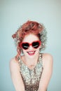 Funny young lady in glitter outfit with red heart shape glasses portrait Royalty Free Stock Photo