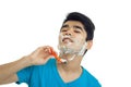 Funny young man with foam on his face leaned back and neck shaves Royalty Free Stock Photo