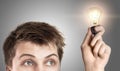 Funny young man with light bulb Royalty Free Stock Photo