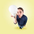 Funny young man with light bulb in his hand Royalty Free Stock Photo