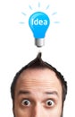 Funny young man with light bulb over his head