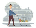 Funny young man with shopping cart buying food at grocery store. Cute boy walking along shelves with products at supermarket.