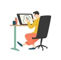 Funny young man sitting at desk and drawing on graphic tablet. Digital designer, illustrator or freelancer working at