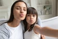 Funny young mom and preschooler daughter make selfie together Royalty Free Stock Photo