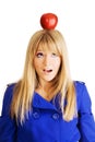 Funny young woman with an apple on her head