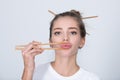 Funny young woman with chopsticks to roll in the mouth. Sexy lips with chopsticks. Royalty Free Stock Photo
