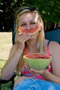 Funny young woman eating watermelon. Close-up Royalty Free Stock Photo