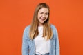 Funny young woman girl in casual denim clothes posing isolated on bright orange wall background studio portrait. People Royalty Free Stock Photo