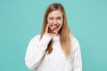 Funny young woman girl in casual white hoodie isolated on blue turquoise background. People lifestyle concept. Mock up Royalty Free Stock Photo