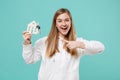 Funny young woman girl in casual white hoodie posing isolated on blue turquoise background studio portrait. People