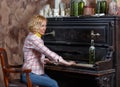 Funny young woman playing shabby retro piano