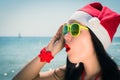 Funny young woman in Santa Claus hat and sunglasses Royalty Free Stock Photo