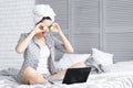 Funny young woman after shower using laptop. Skin care concept Royalty Free Stock Photo