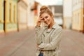 Funny young woman with a sweet smile in a fashionable jacket