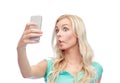 Funny young woman taking selfie with smartphone Royalty Free Stock Photo