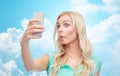 Funny young woman taking selfie with smartphone Royalty Free Stock Photo