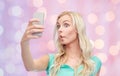 Funny young woman taking selfie with smartphone Royalty Free Stock Photo