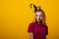 Funny young woman wearing witch costume for Halloween party. Happy Halloween witch with a black hat Royalty Free Stock Photo