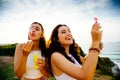 Funny young women blowing bubbles Royalty Free Stock Photo