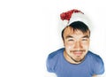 Funy exotical asian Santa claus in new years red hat smiling Royalty Free Stock Photo